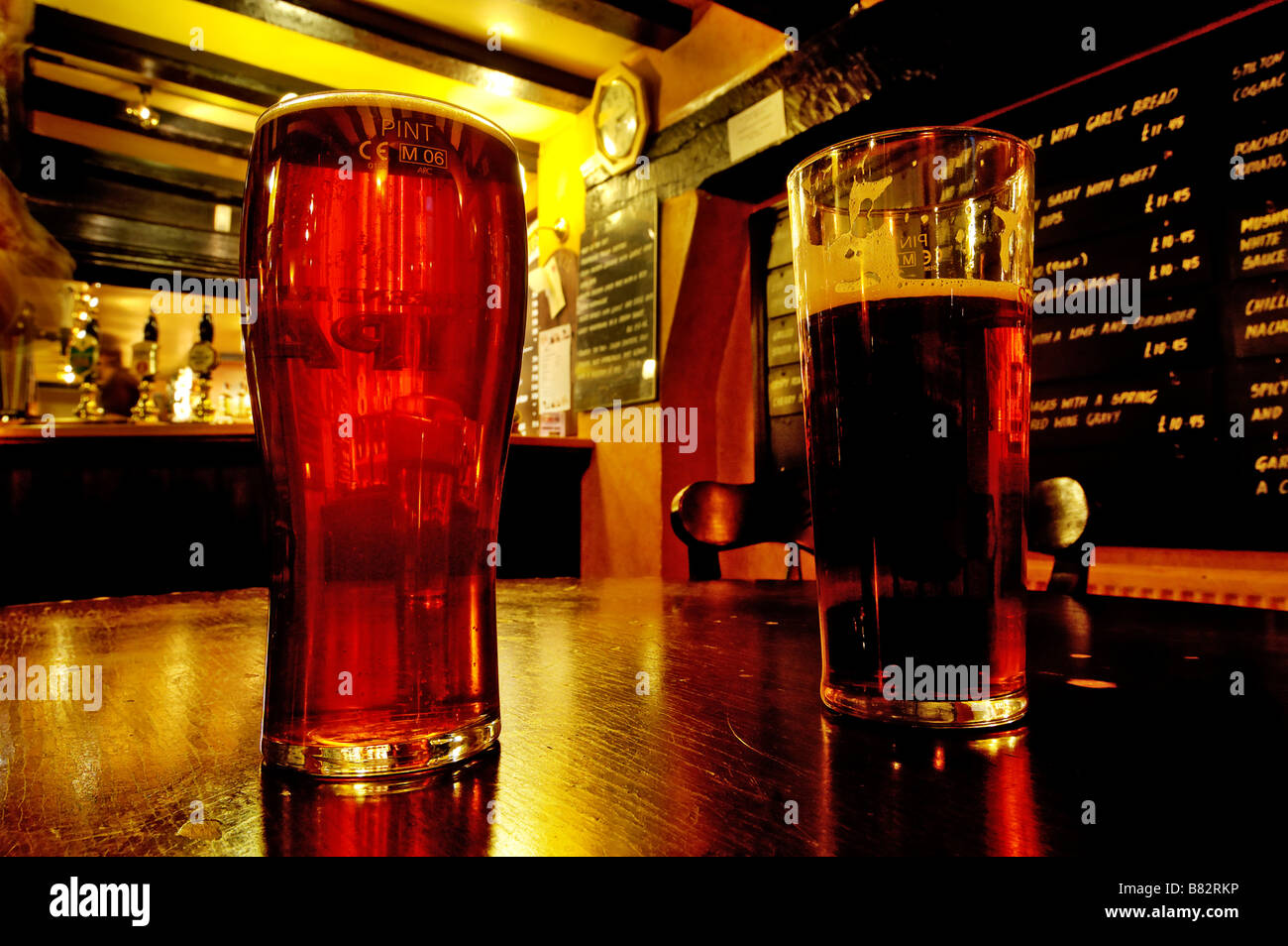 Two pints of beer on a table in a pub Stock Photo