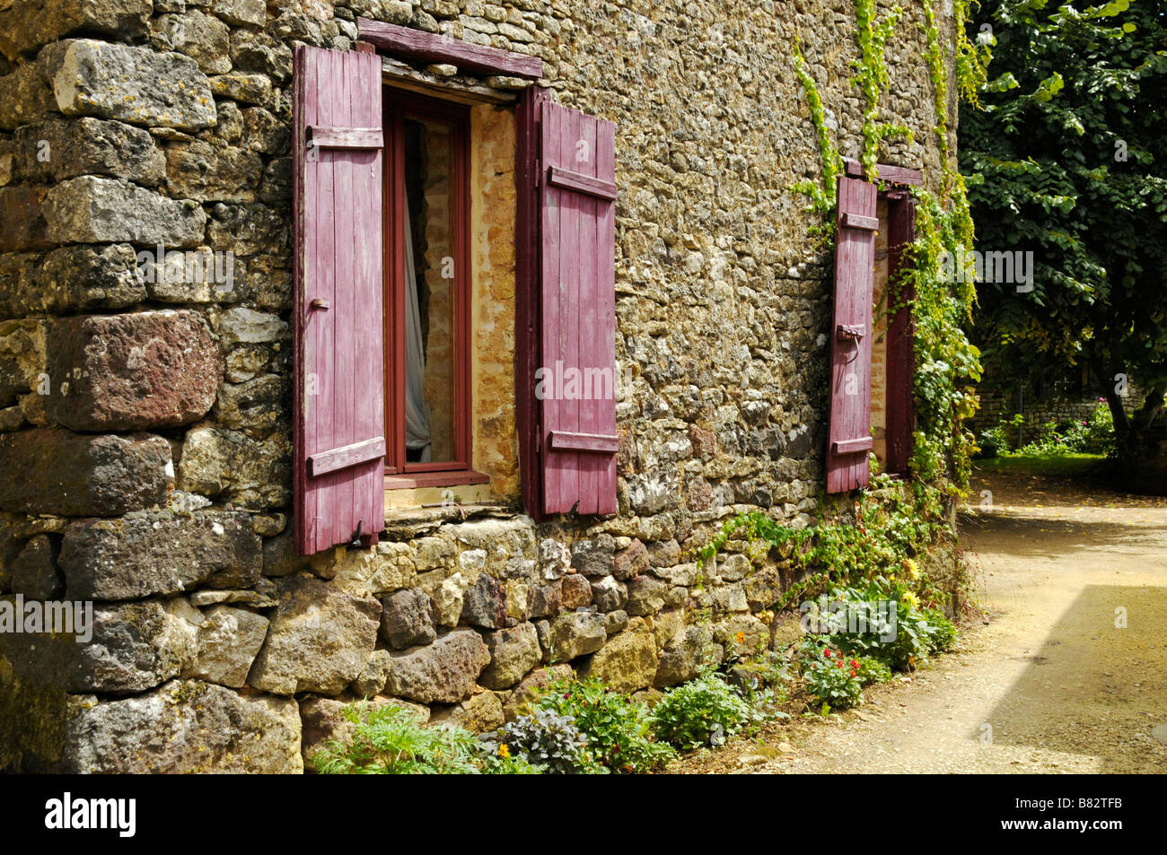 Pretty French house surrounded with flowers Stock Photo