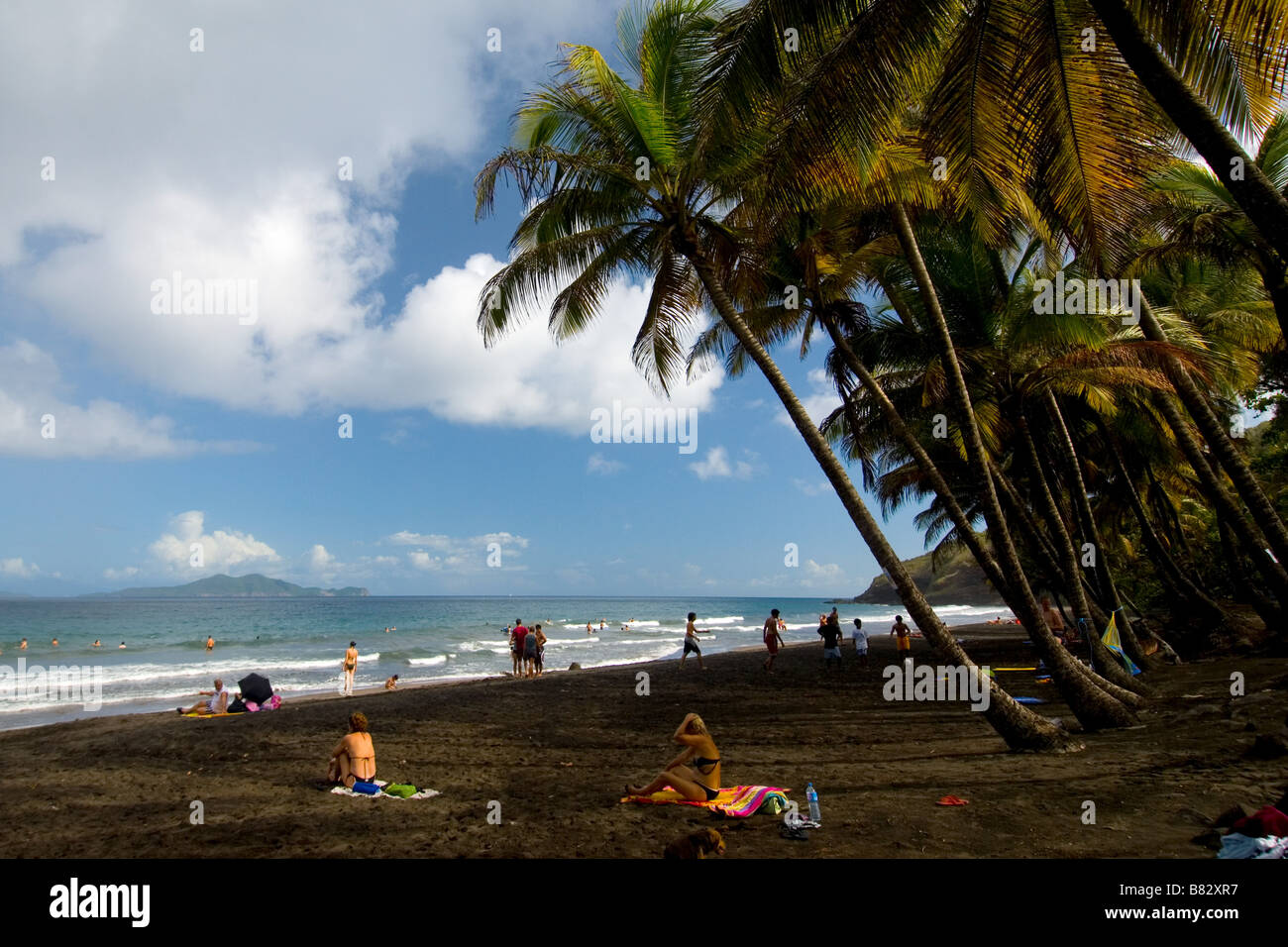 Nicaragua,  Black beach volcanic sand, palm trees, paradise, people at beach Stock Photo