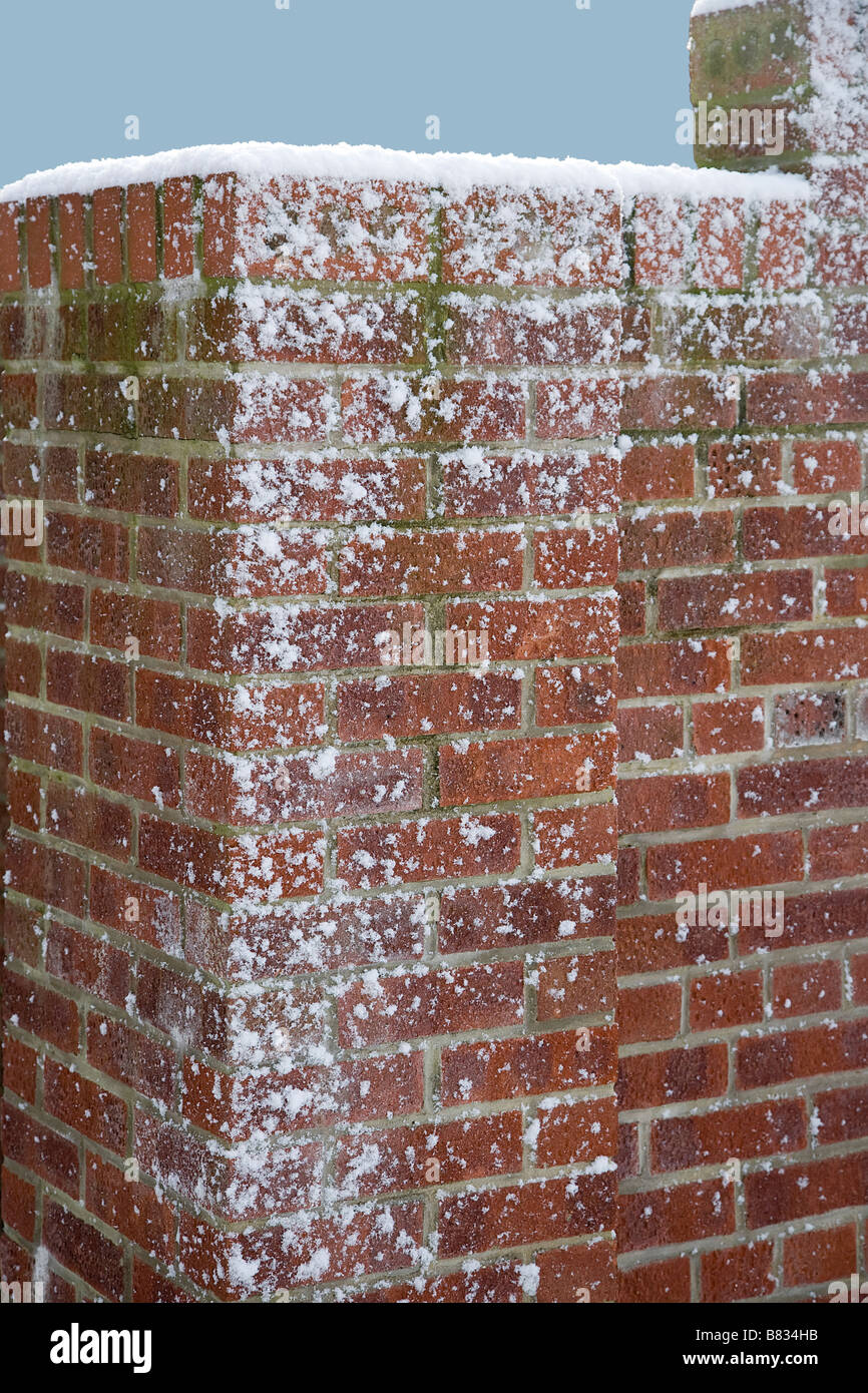Snow blasted red brick wall Stock Photo