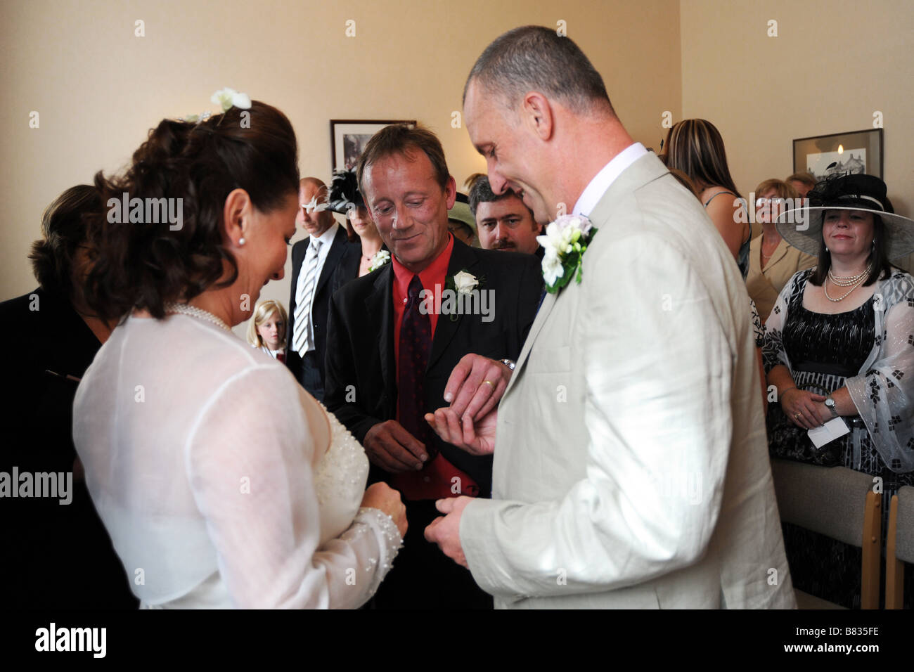 A Best man hands the wedding rings to a Newly wed couple North Yorkshire Stock Photo