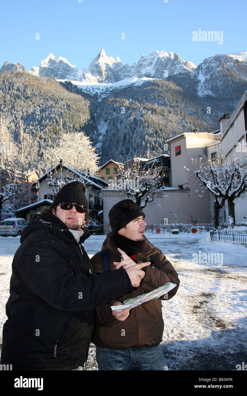 Two tourists lost in Chamonix-Mont-Blanc, looking at a map of the city Stock Photo