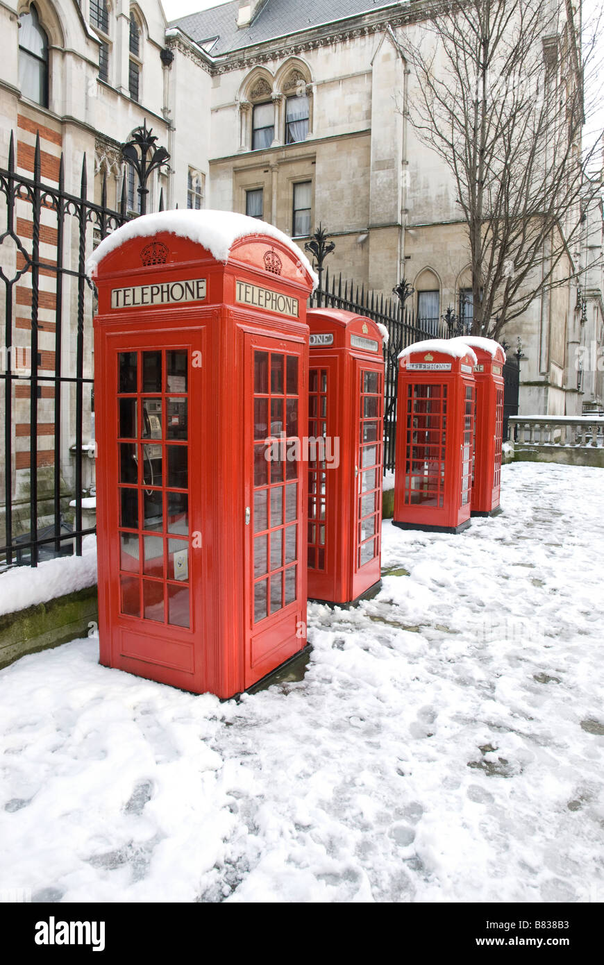 4 red telephone boxes in snow in London Stock Photo Alamy