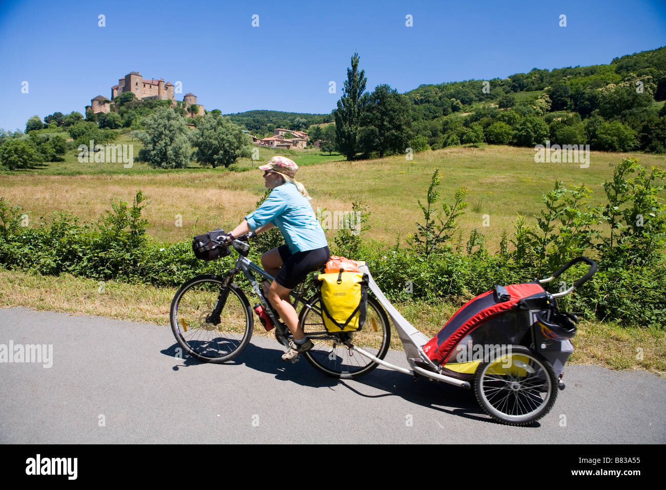 Cyclist with child trailer on the Voie Verte trail near Cluny Stock Photo