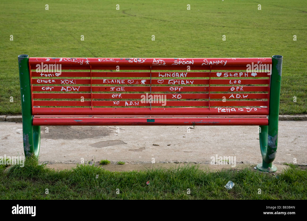 Graffiti on park bench Marrowbone Milennium Park Oldpark Belfast. Stock Photo