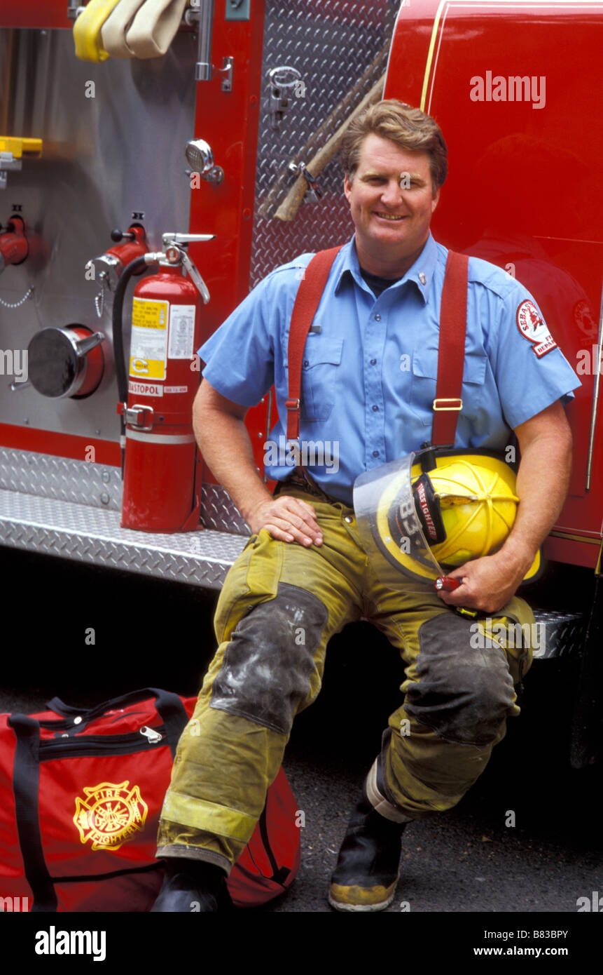 Fireman sitting on firetruck, USA Stock Photo - Alamy