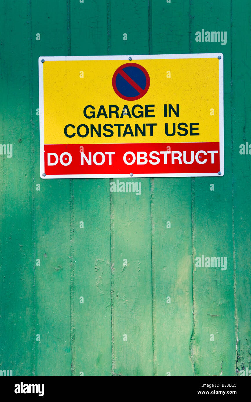 Garage in Constant Use Do Not Obstruct Sign on garage door Stock Photo