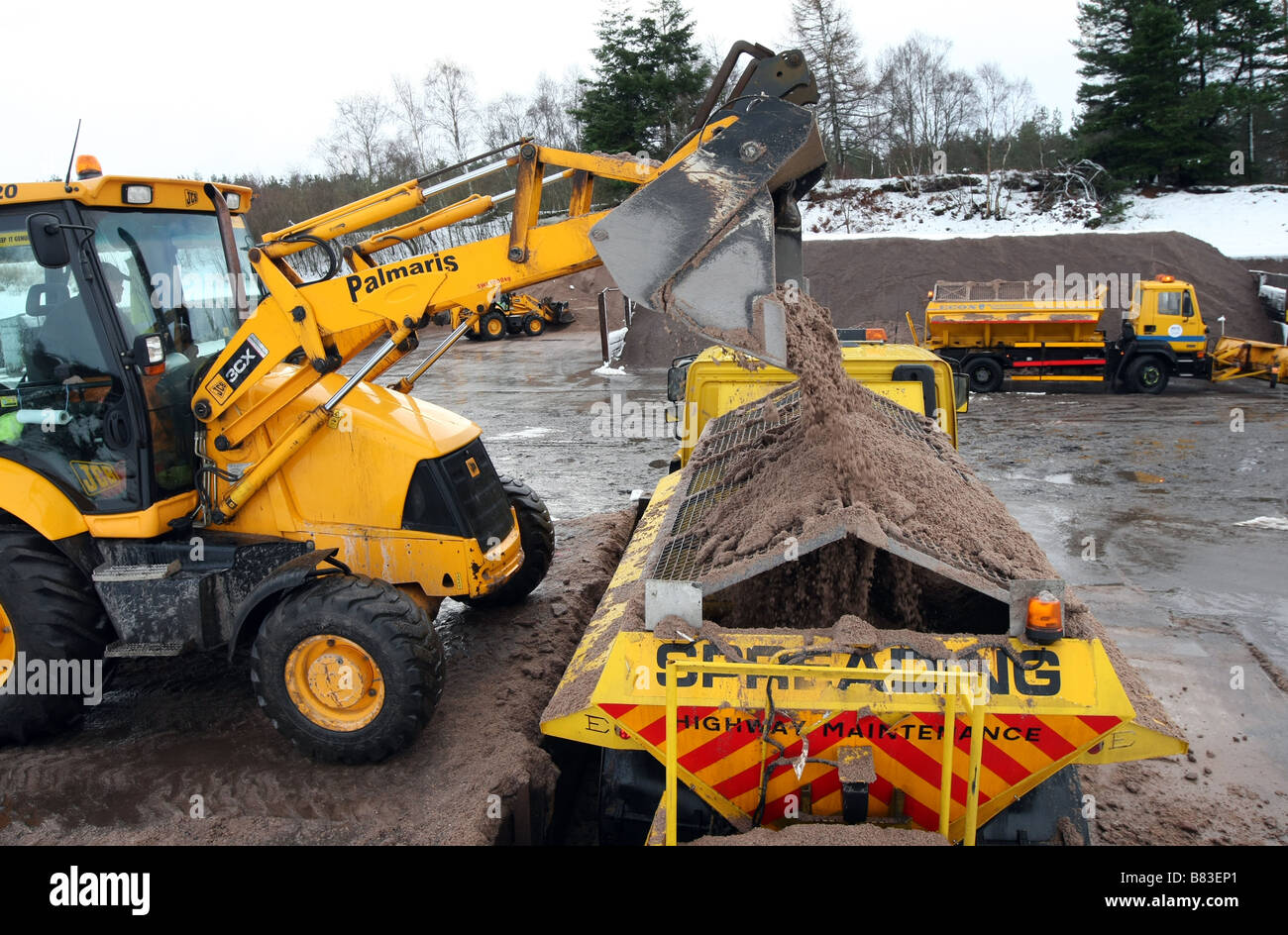 Gritters and snow ploughs being loaded with road grit at council roads depot in Aberdeenshire, scotland, UK Stock Photo