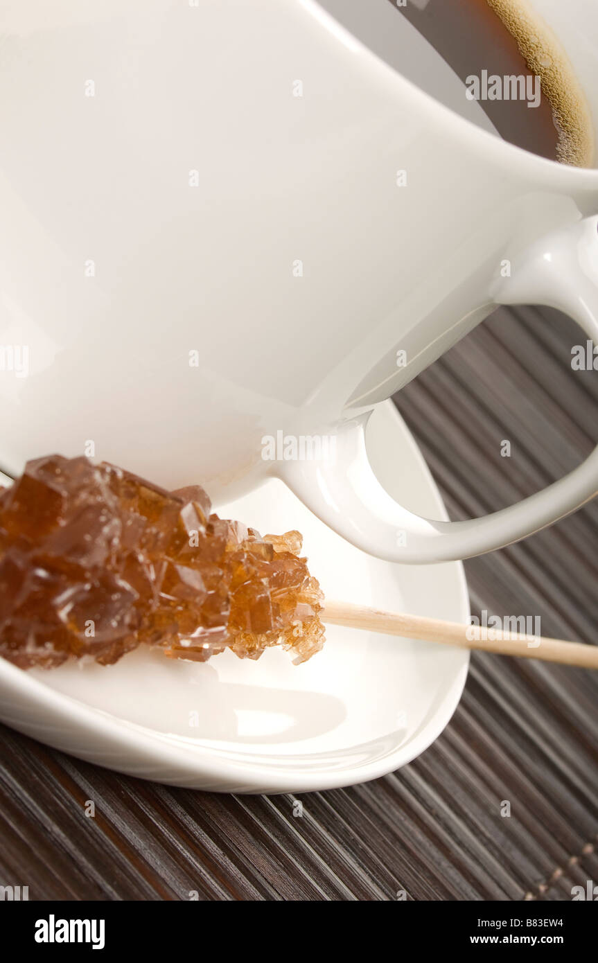 White coffee cup and saucer with sugar stick close up Stock Photo