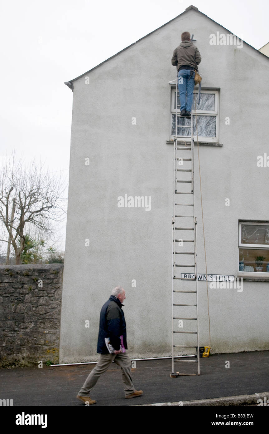 A workman on a ladder. Stock Photo
