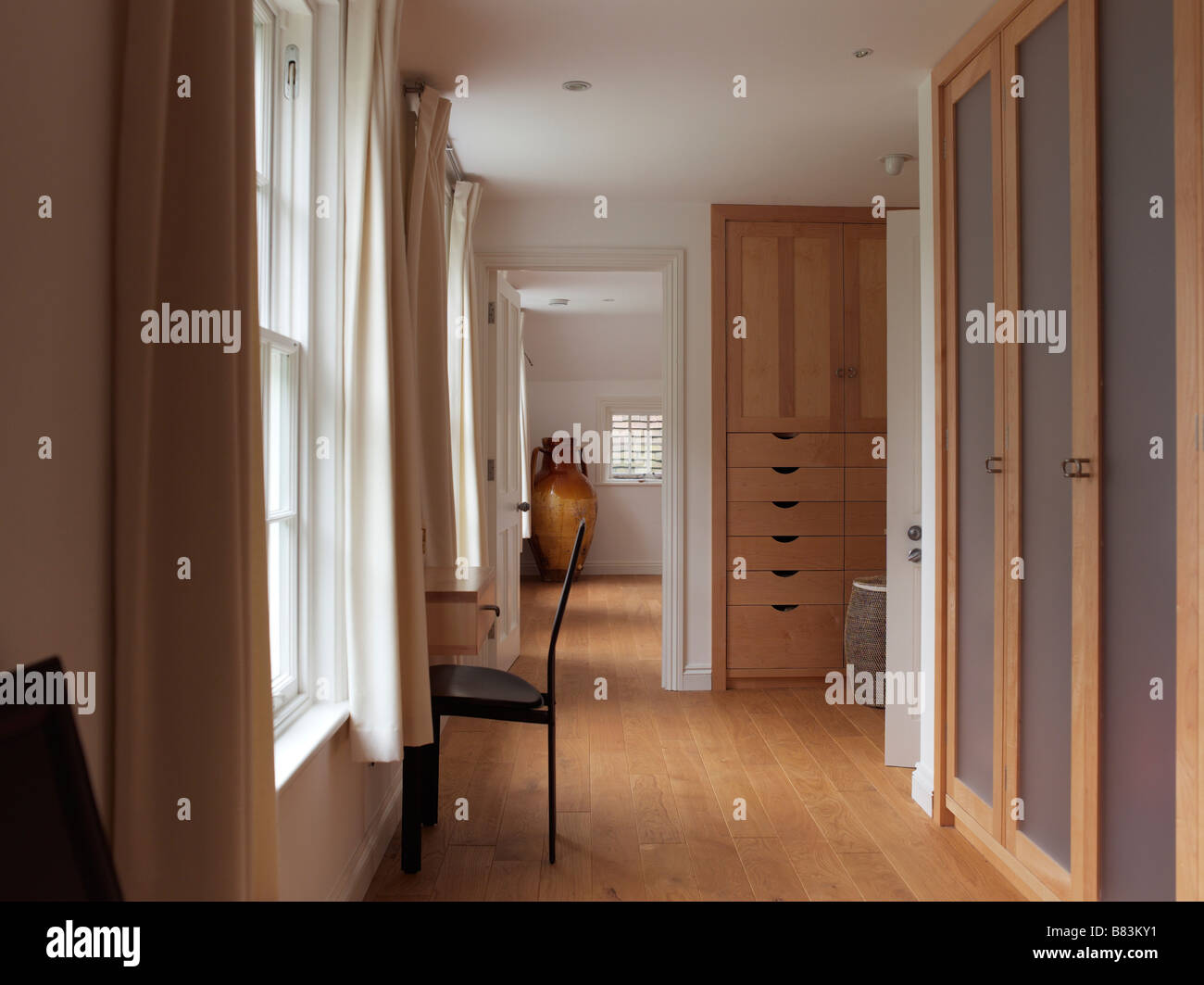 Bedroom With Built In Wardrobes And Drawers With Wooden Flooring
