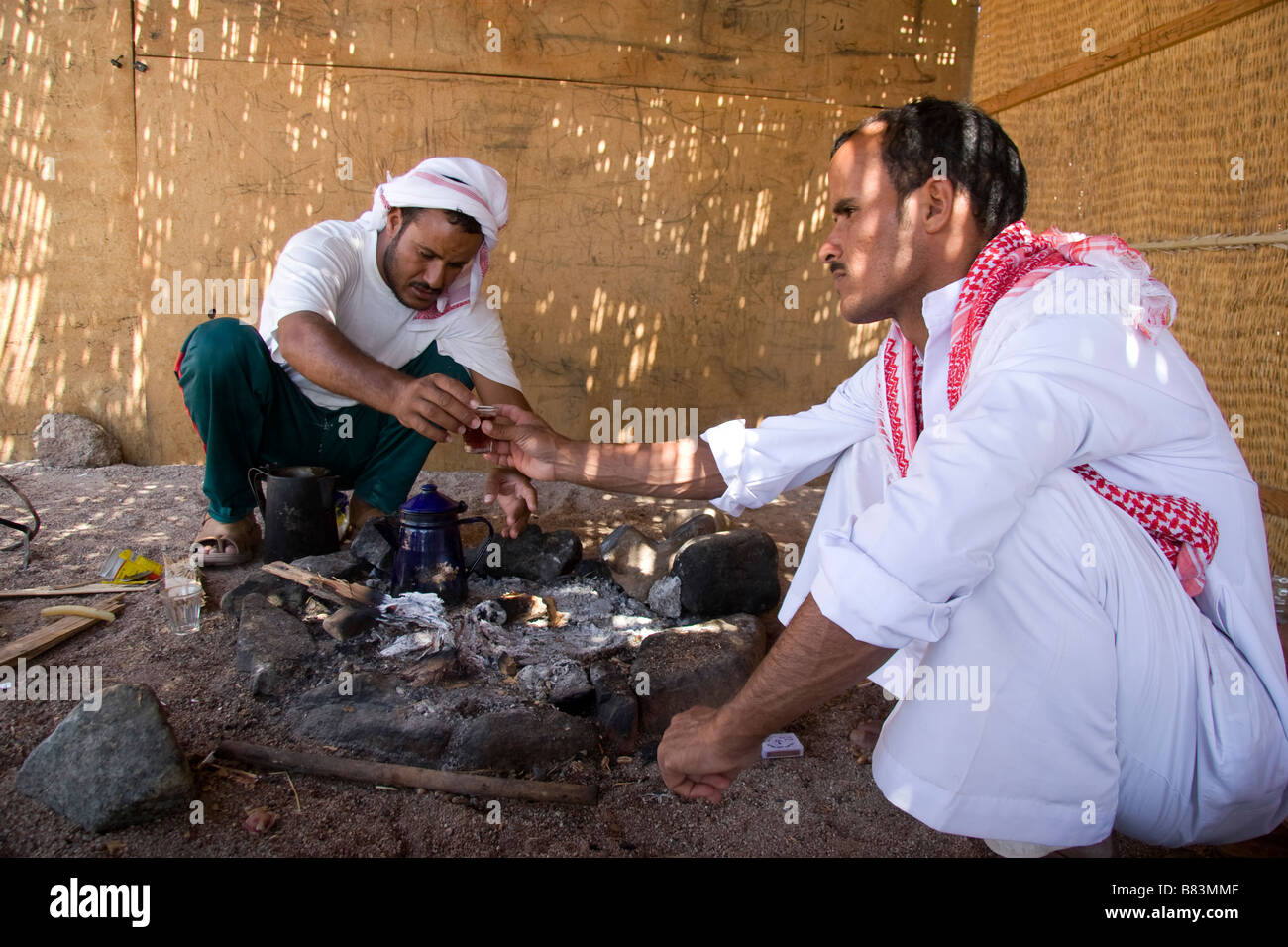 Bedouin host welcomes guests with customary tea in the village of Ras Abu Gallum, north of the Sinai resort of Dahab in Egypt Stock Photo