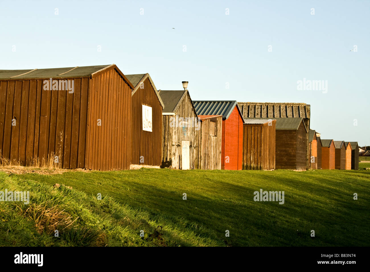 Row of multi-coloured small wooden garages on a small hill in Buckie, Scotland Stock Photo