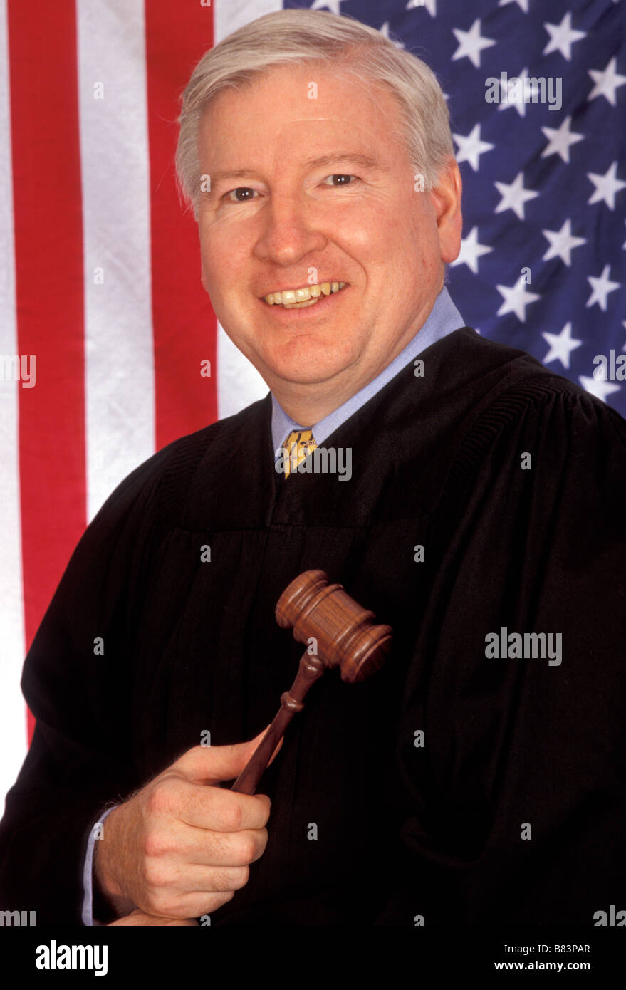 Judge in robe with gavel in front of US Flag Stock Photo Alamy