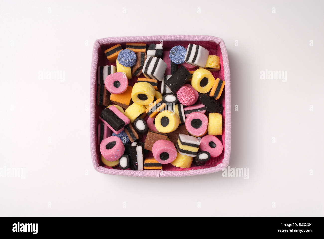 Liquorice allsorts sweets in pink box Stock Photo