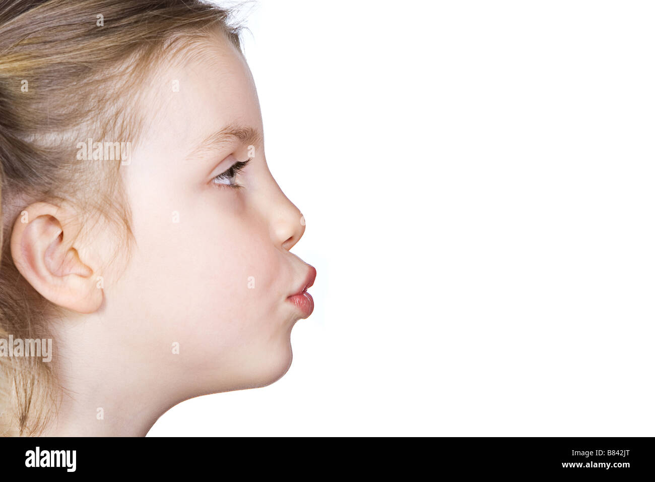 Side Profile Shot of Cute Child Pursing Lips to Kiss Stock Photo Alamy