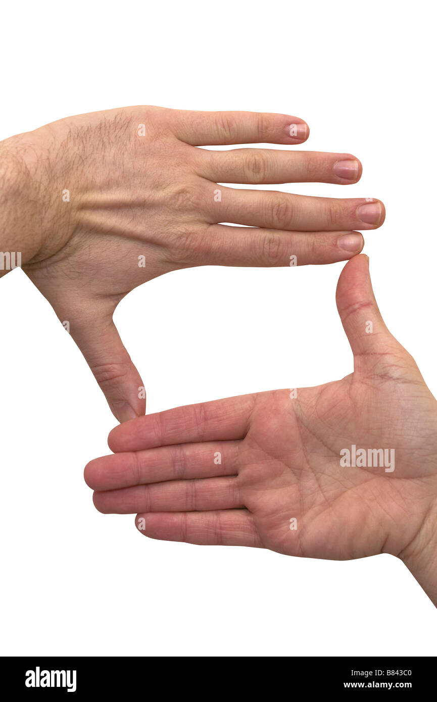 Cutout of two hands in colour used to frame a scene / picture / photograph. Stock Photo