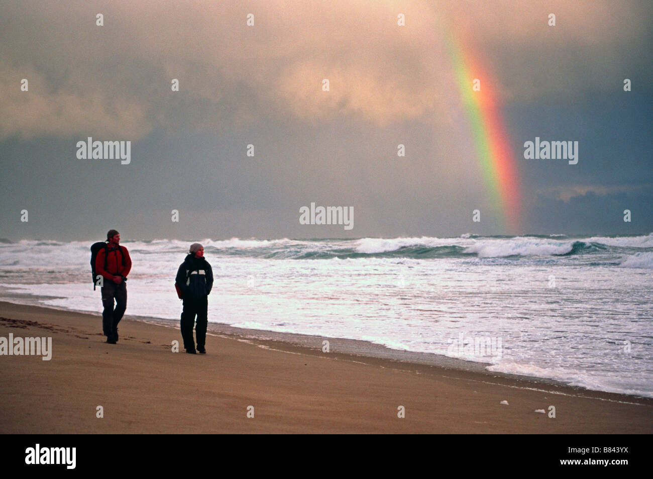 A couple hikes on a stormy day on Johanna Beach, Great Ocean Walk, Victoria, Australia Stock Photo