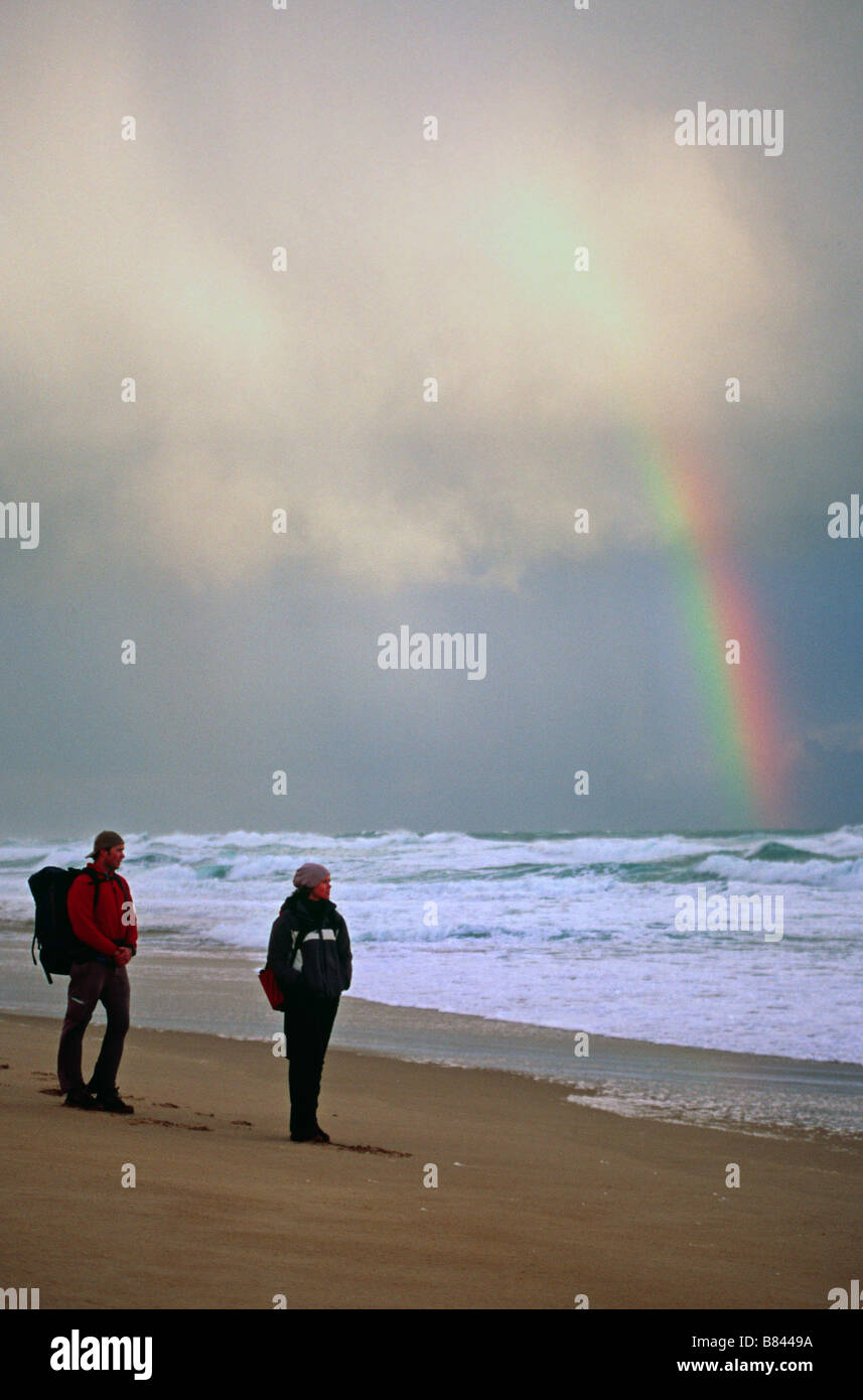 A couple hikes on a stormy day on Johanna Beach, Great Ocean Walk, Victoria, Australia Stock Photo