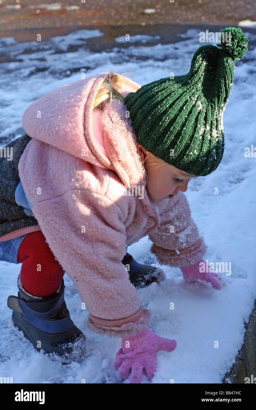 Child Making Snowballs Little girl (3 years old) starting to make a snowball Stock Photo - Alamy