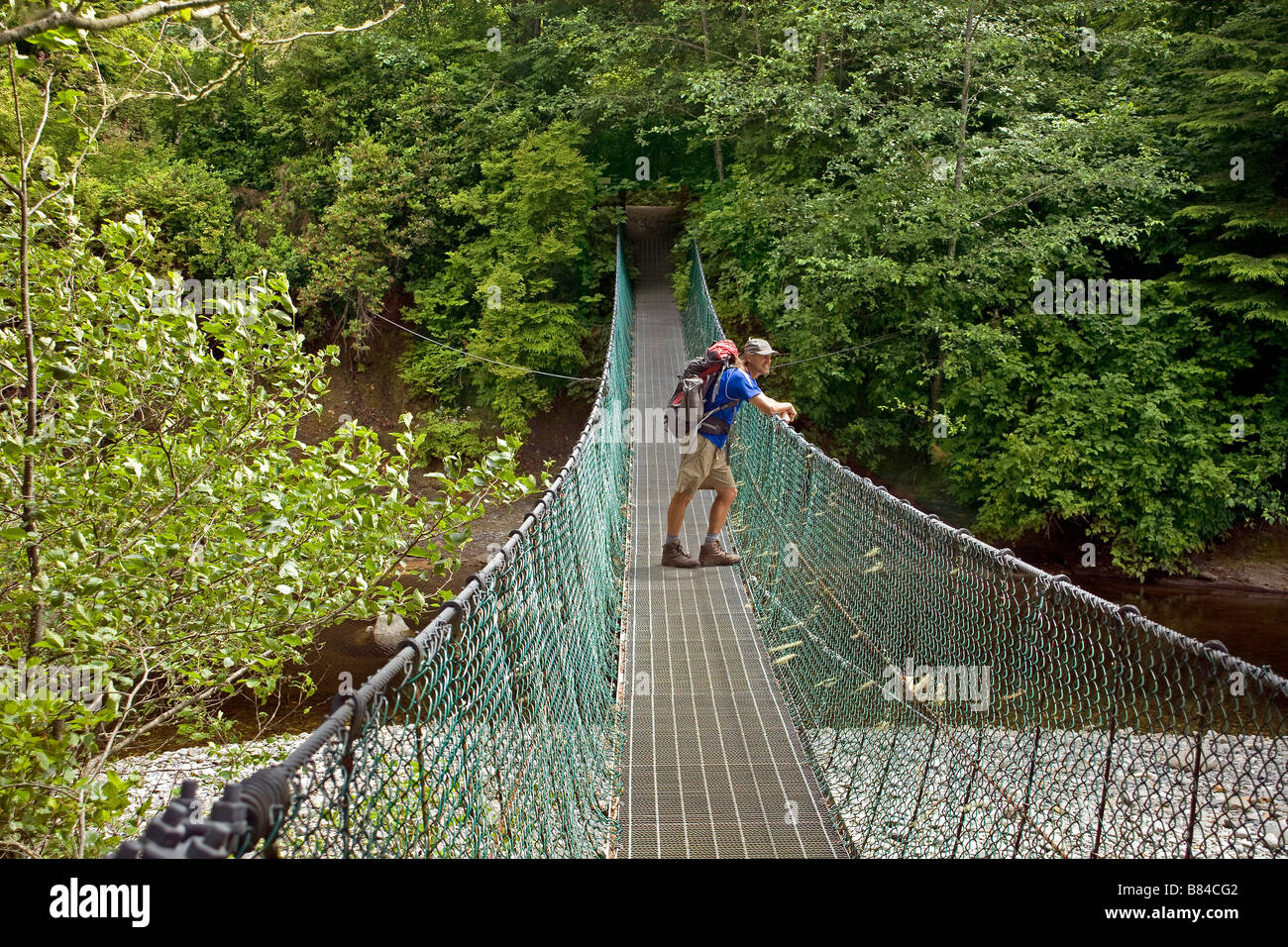 BRITISH COLUMBIA Hiker on the Sombrio River suspension bridge on Juan