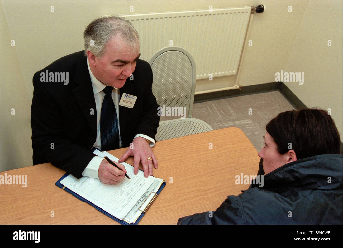 Probation Officer talking to a woman about her bail conditions Stock Photo