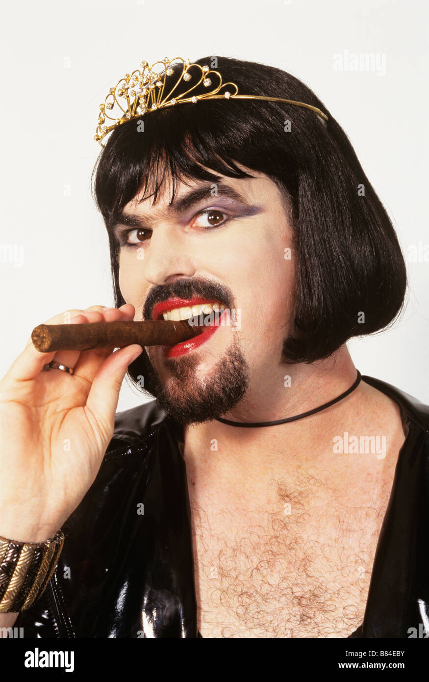 Drag queen with beard and cigar, wearing tiara Stock Photo