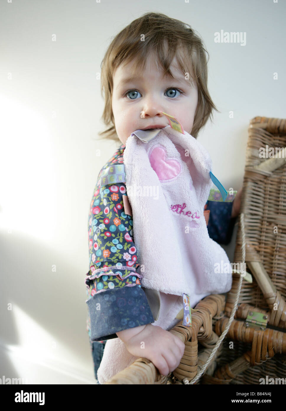 A One Year Old Baby Girl Chewing On A Comfort Blanket Stock Photo