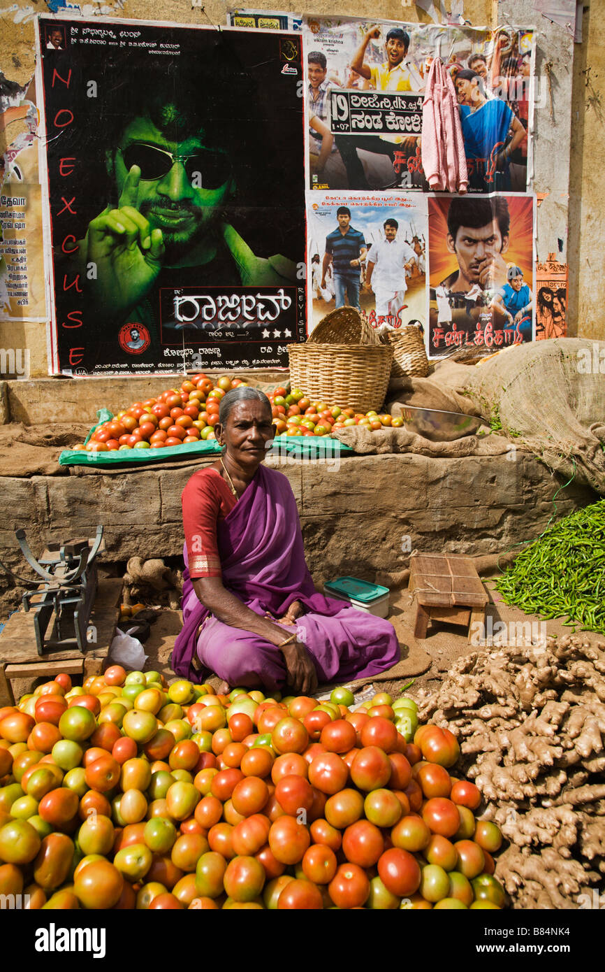 Vegetable vendor below Tamil movie posters in Mysore, Karnataka State, India Stock Photo