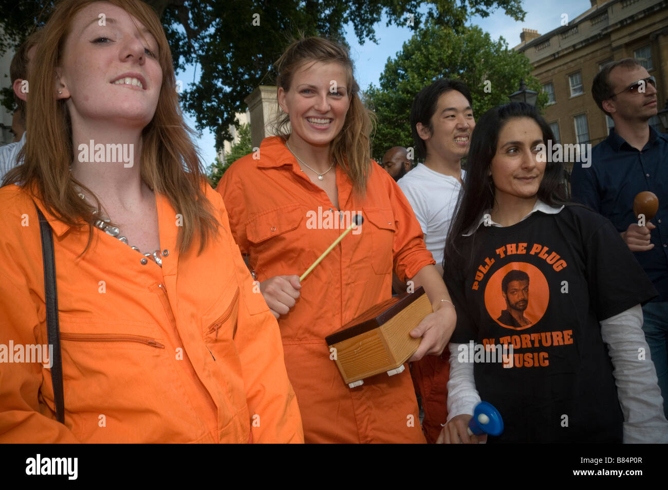 People in orange jumpsuits at Downing St protest on birthday of Binyam ...