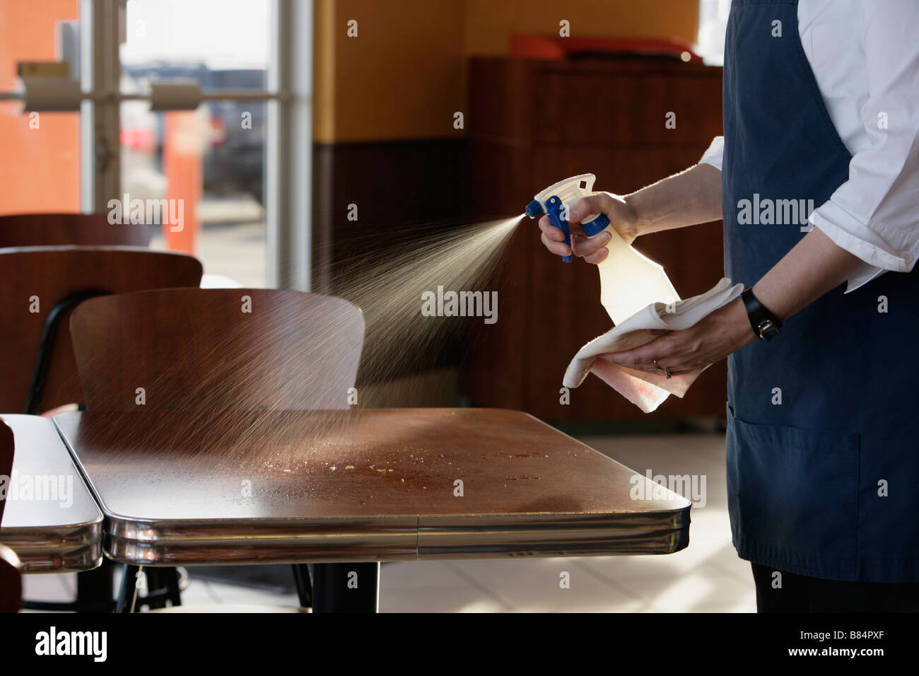 Person cleaning tables Stock Photo Alamy