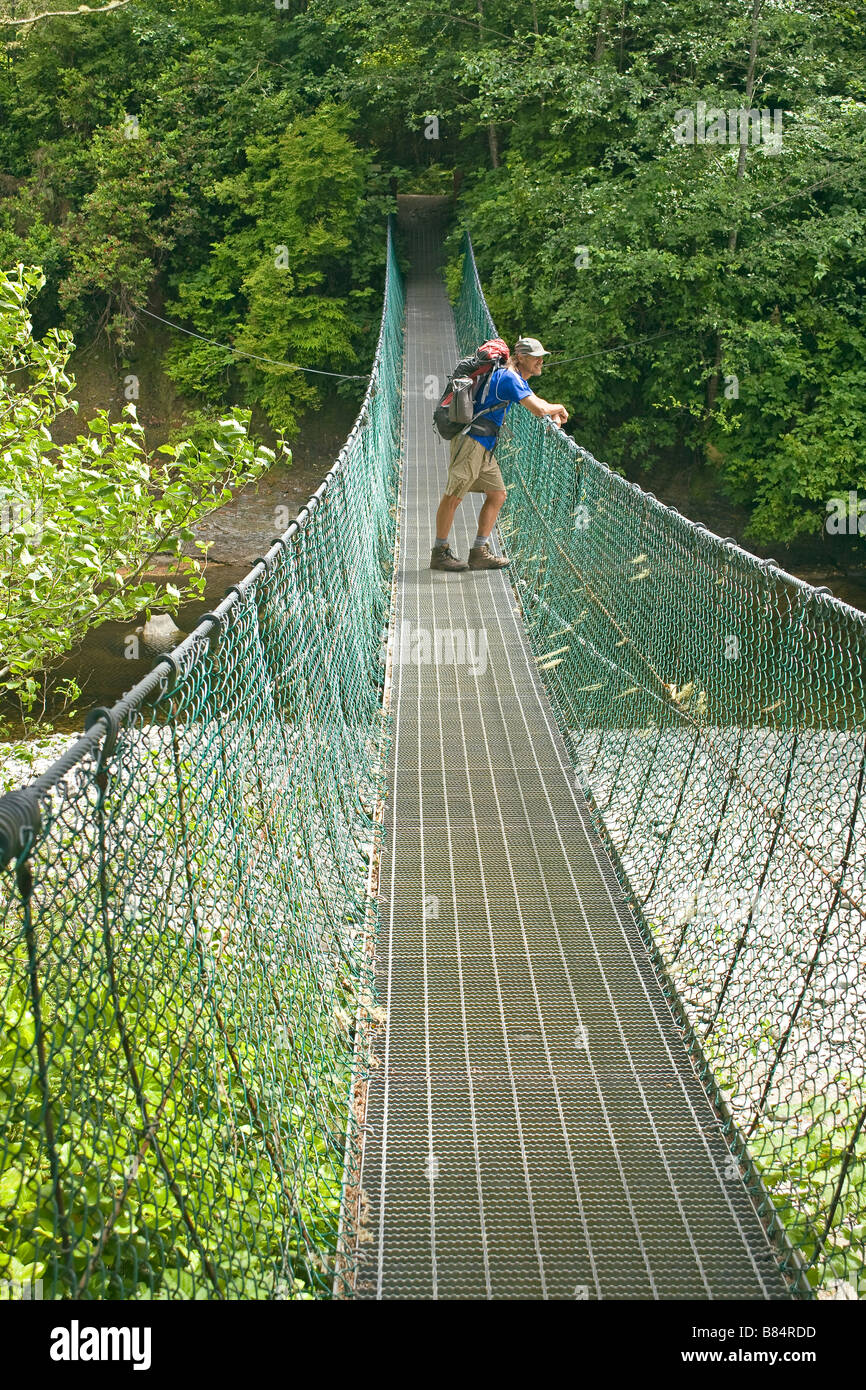BRITISH COLUMBIA Hiker on the Sombrio River suspension bridge on Juan