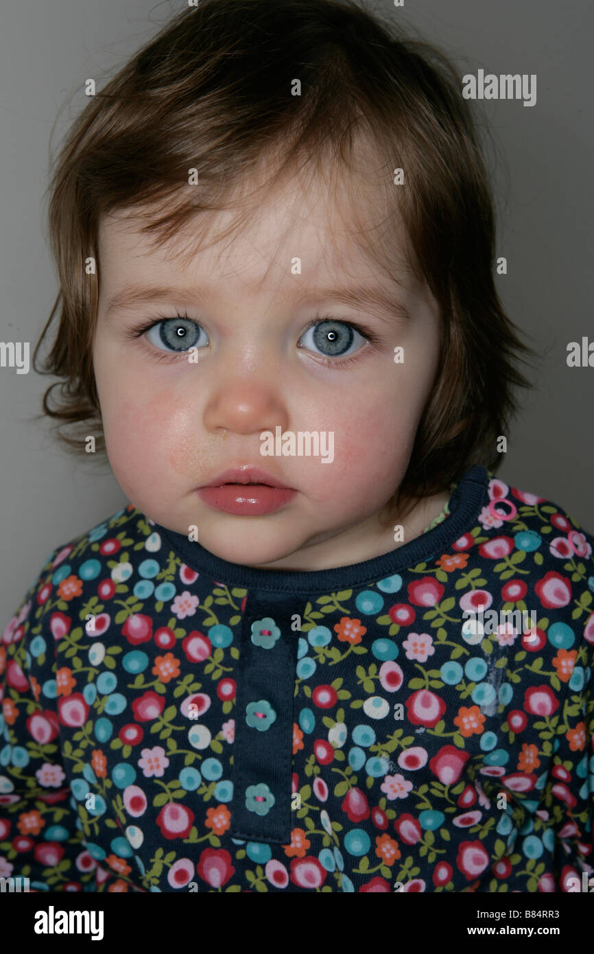 A one year old baby girl with bright blue eyes Stock Photo Alamy