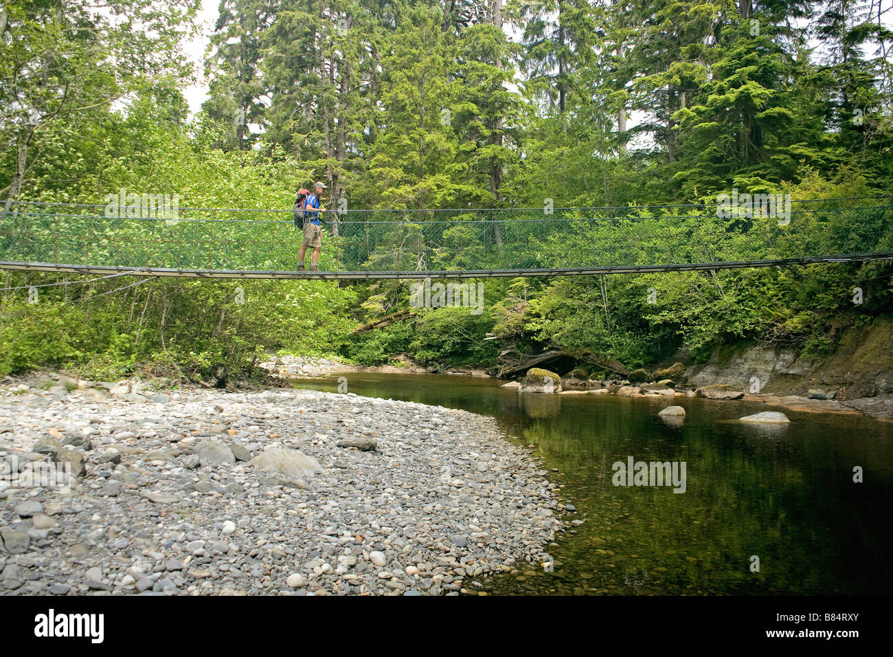 BRITISH COLUMBIA Hiker on the Sombrio River suspension bridge on Juan