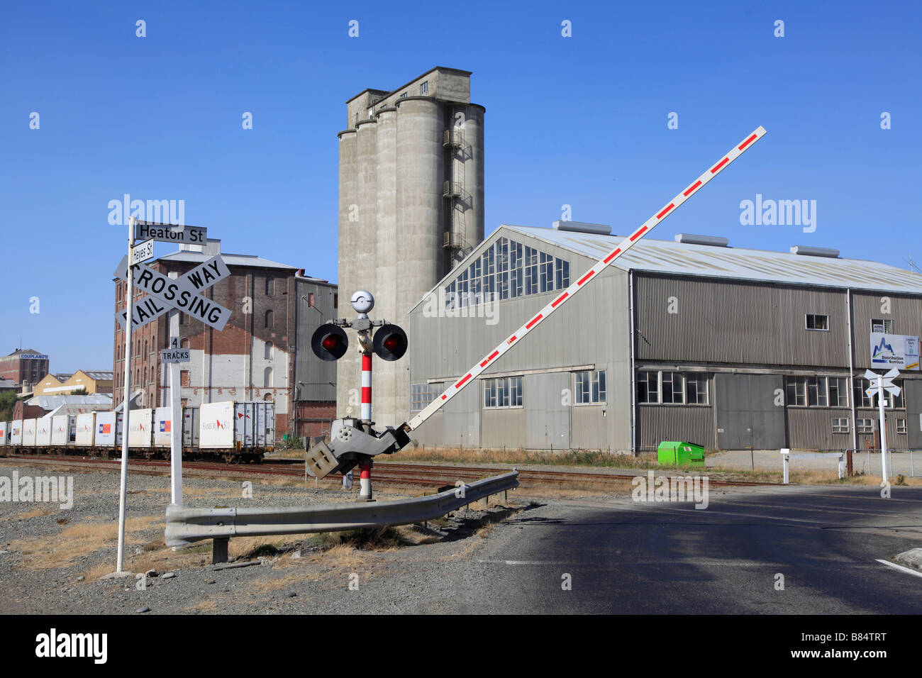 Barrier at railway crossing coming down,Timaru,Canterbury,South Island,New Zealand Stock Photo