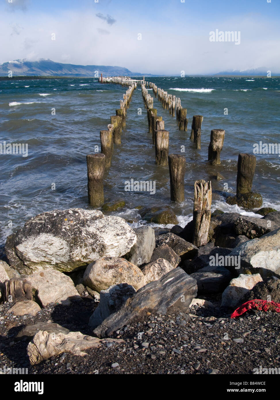 Old pier on rocky strand, Punta Arenas Patagonia Chile South America Stock Photo