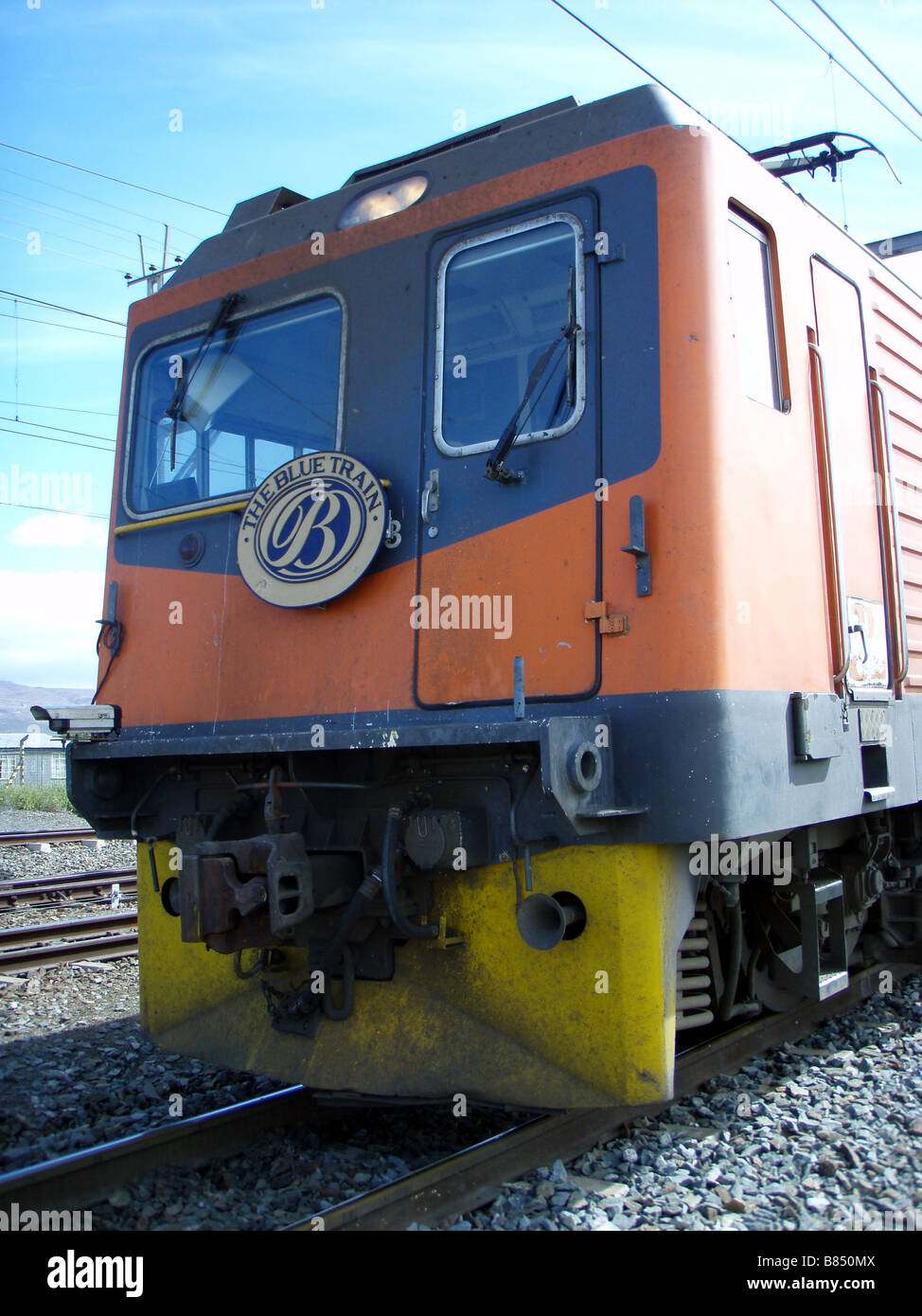 Blue Train Crossing Barren Karoo in South Africa Stock Photo