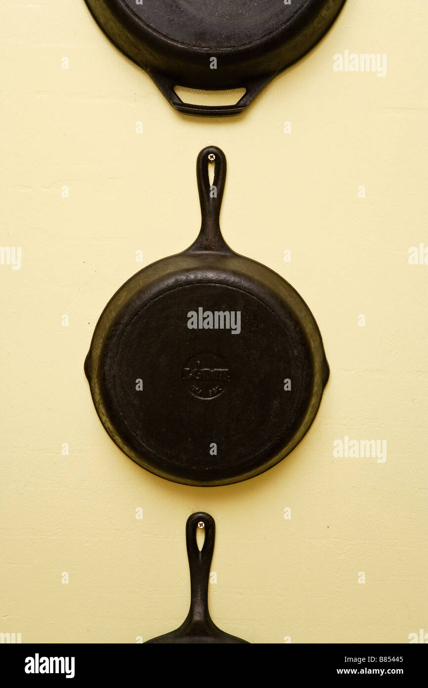 Iron Skillets hanging on a wall Stock Photo Alamy