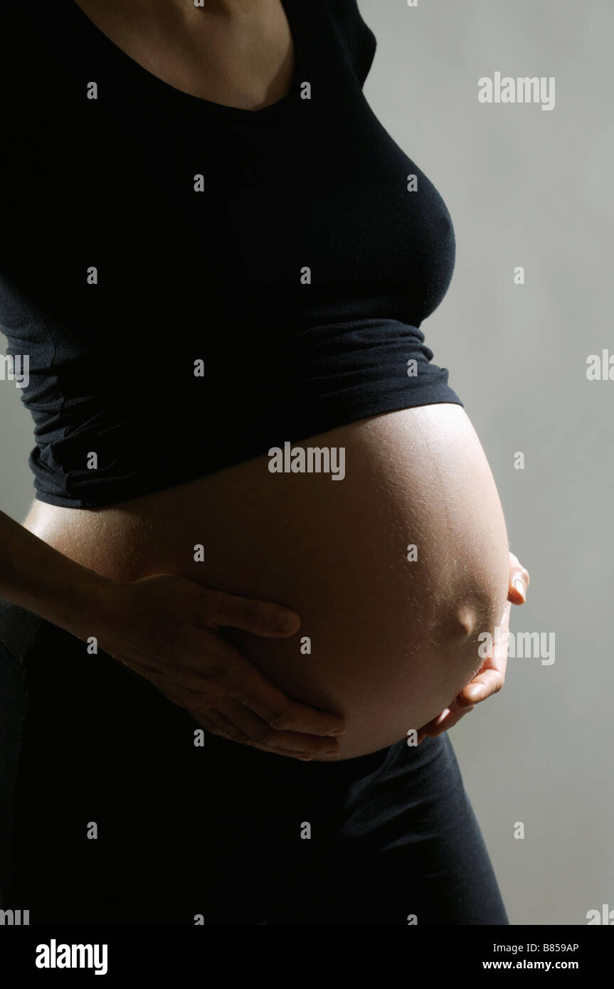 detail of pregnant woman holding her belly Stock Photo Alamy