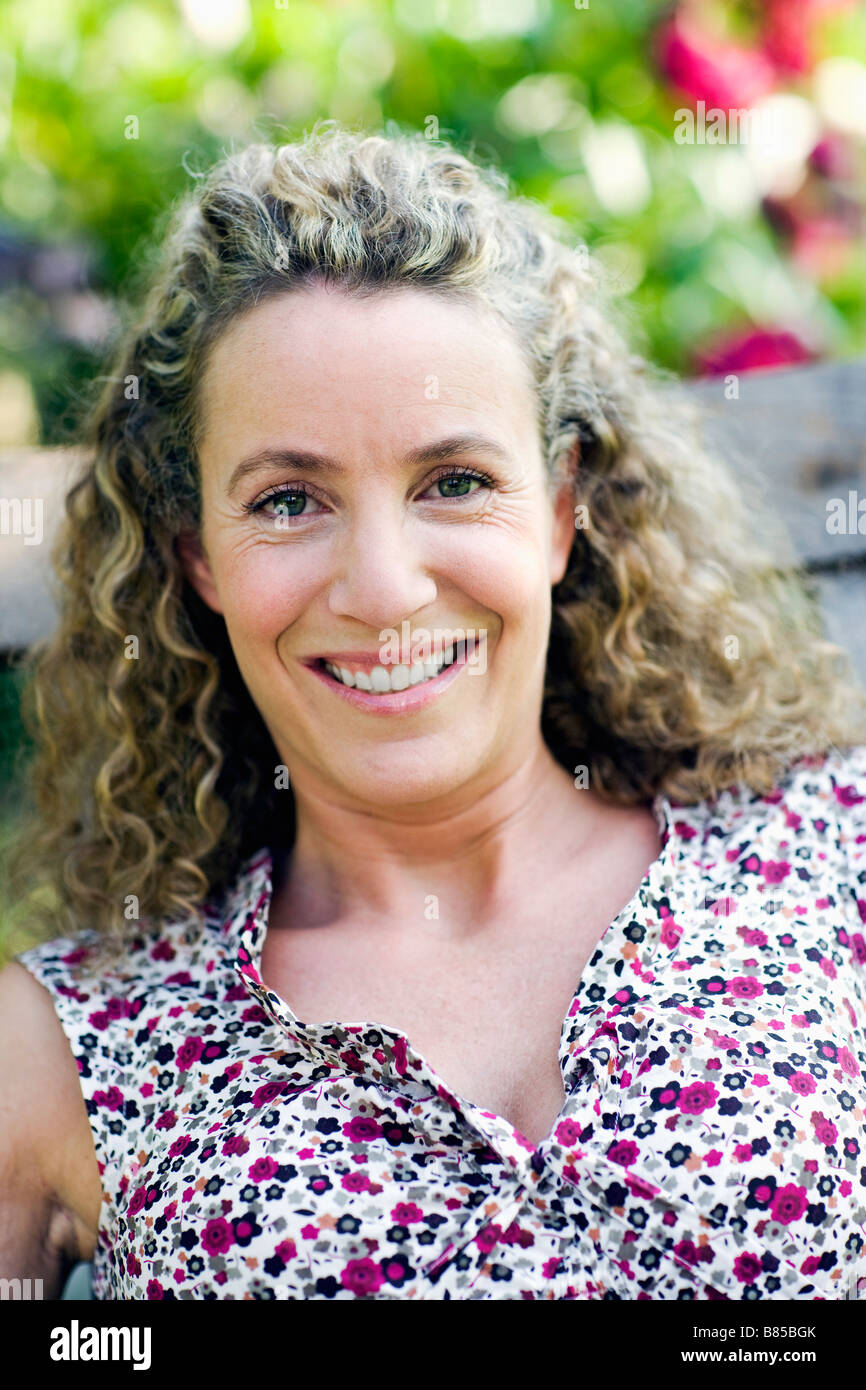 portrait of woman sitting in garden Stock Photo - Alamy