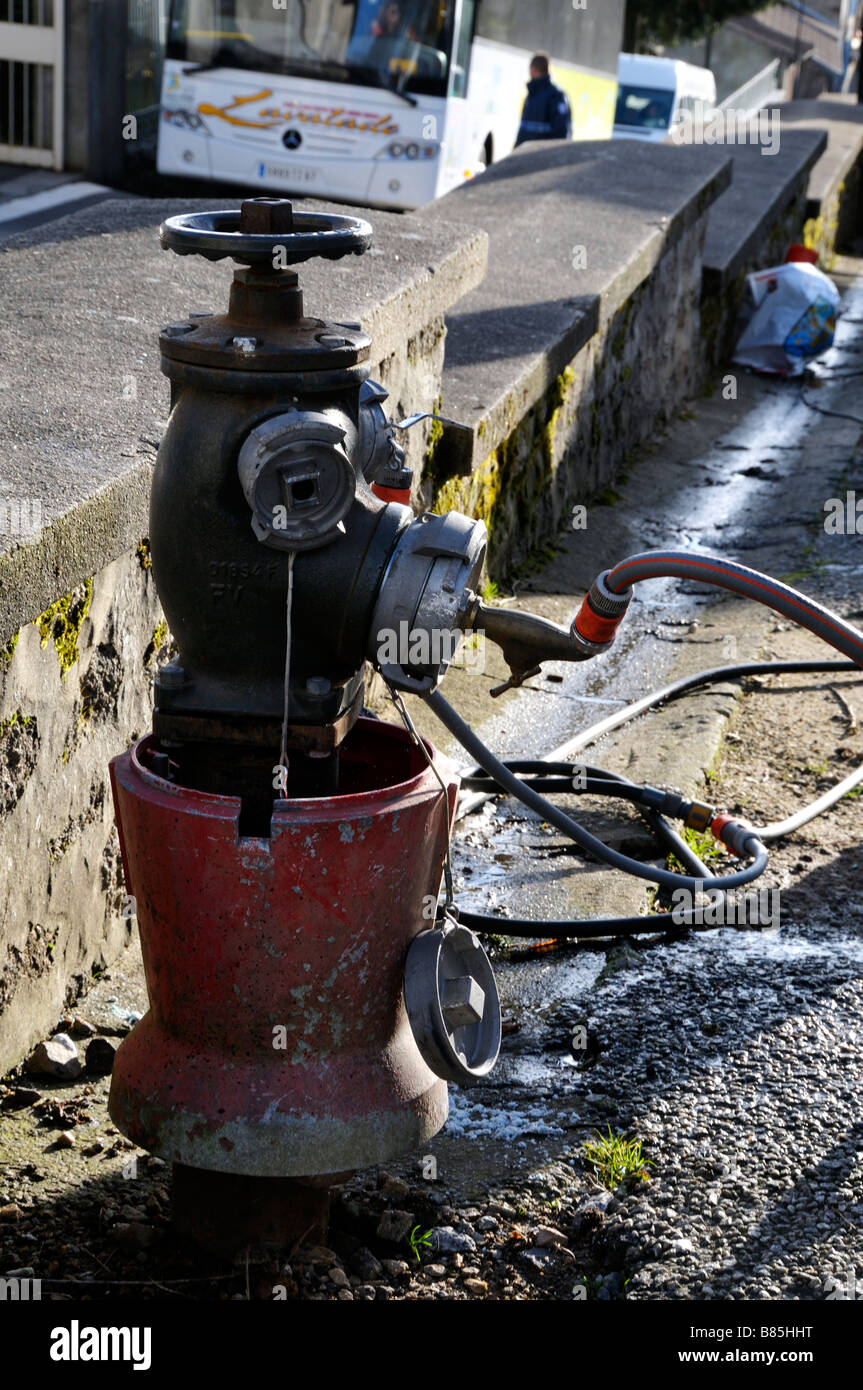 Stock photo of a fire hydrant with many hoses connected to it Stock