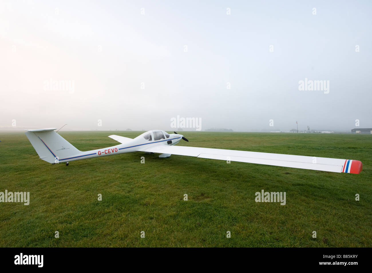 GROB G109B fixed wing self launching motor glider waiting on the ground on a misty morning Stock