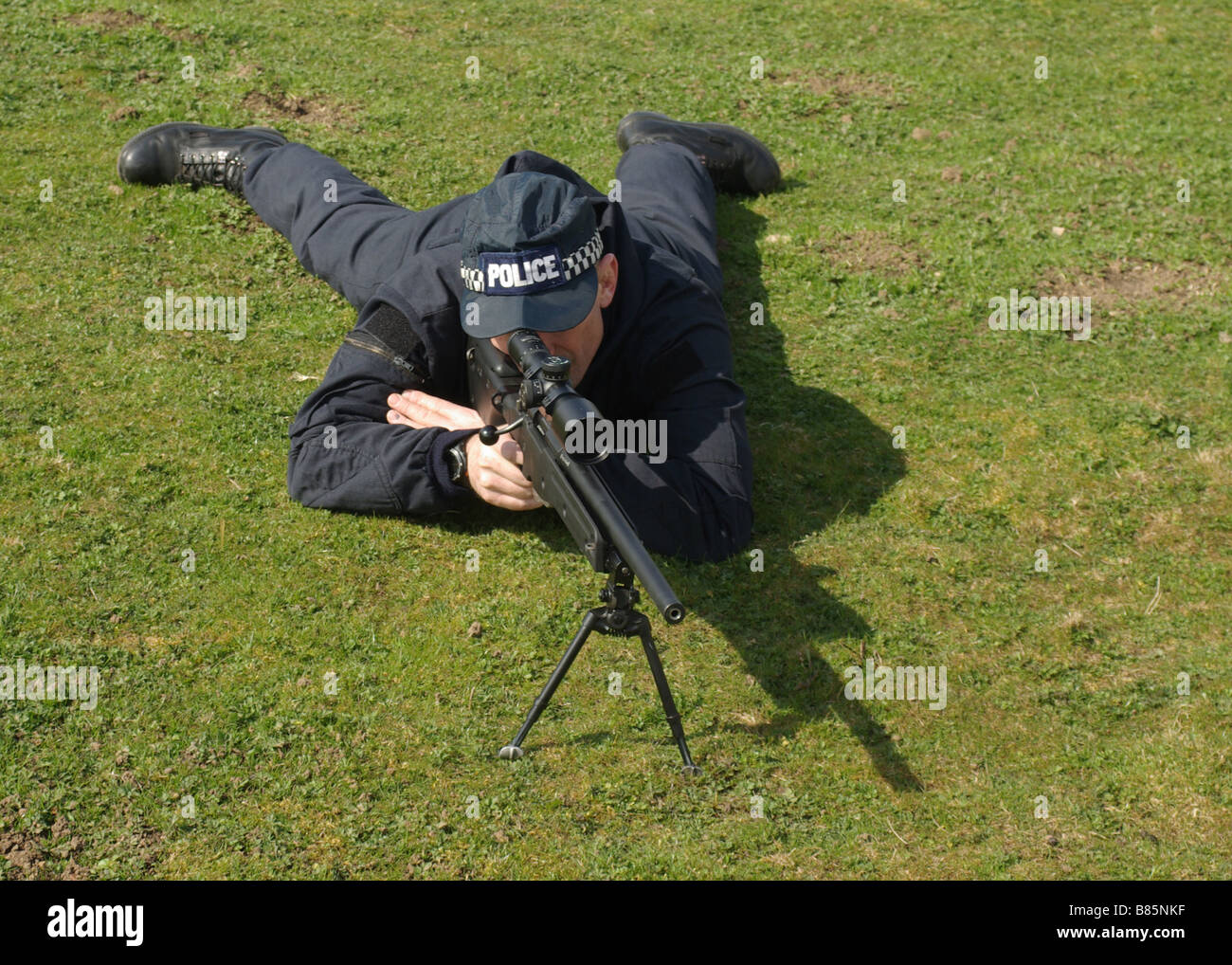 Police sniper with 7 62 Accuracy International AWP rifle in prone position Stock Photo