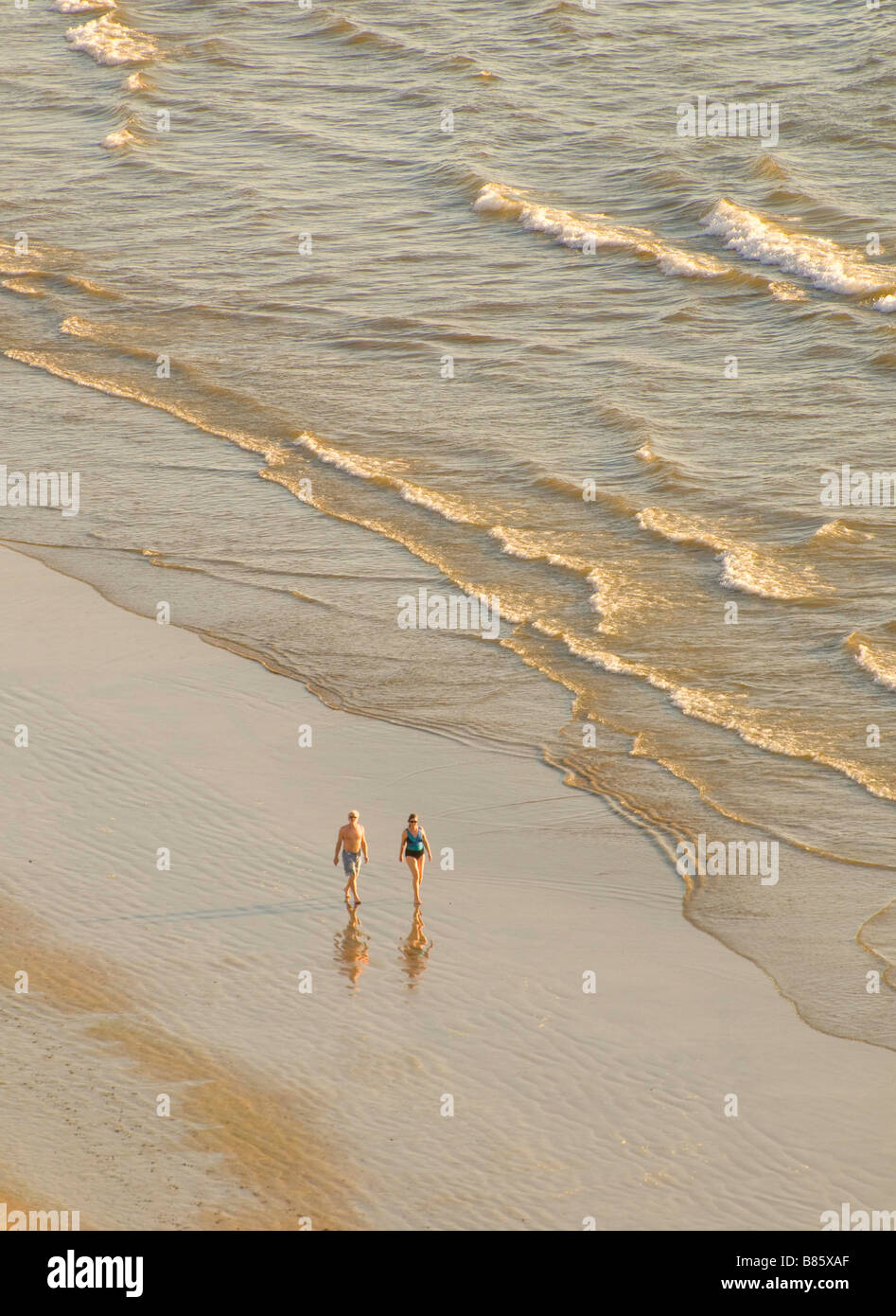 MEXICO SINOLA STATE MAZATLAN Man and Woman enjoying the day walking the beach Golden Zone Stock Photo