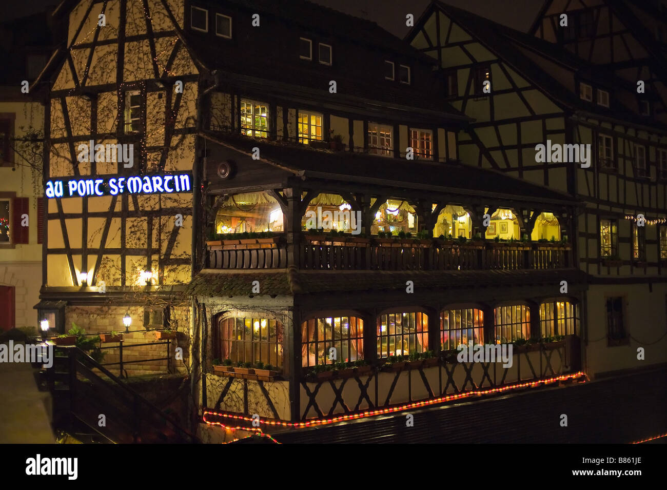 Half-timbered house with restaurant at night, La Petite France district, Strasbourg, Alsace, France Stock Photo