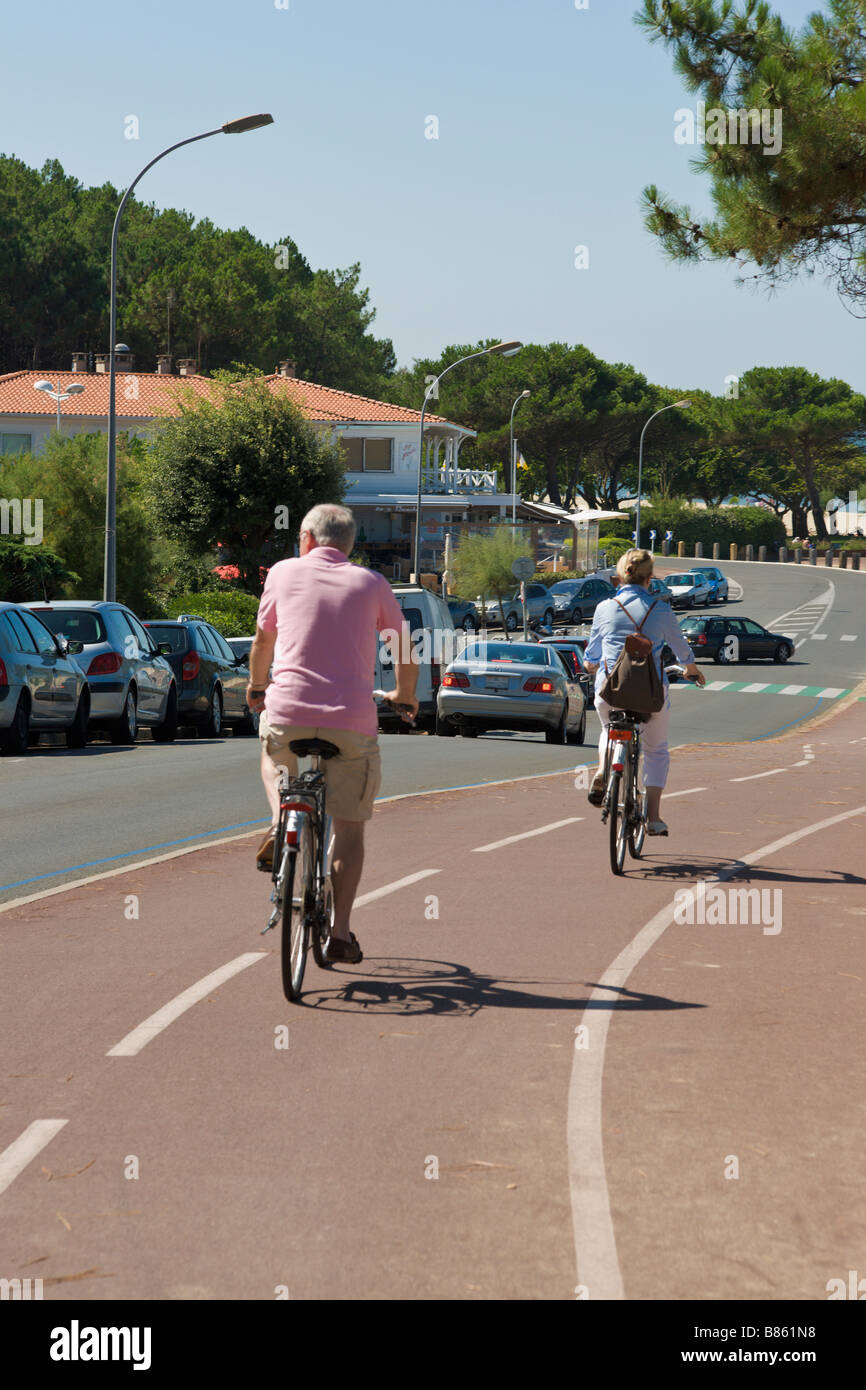 Two people riding on cycle path, Gironde, France Stock Photo