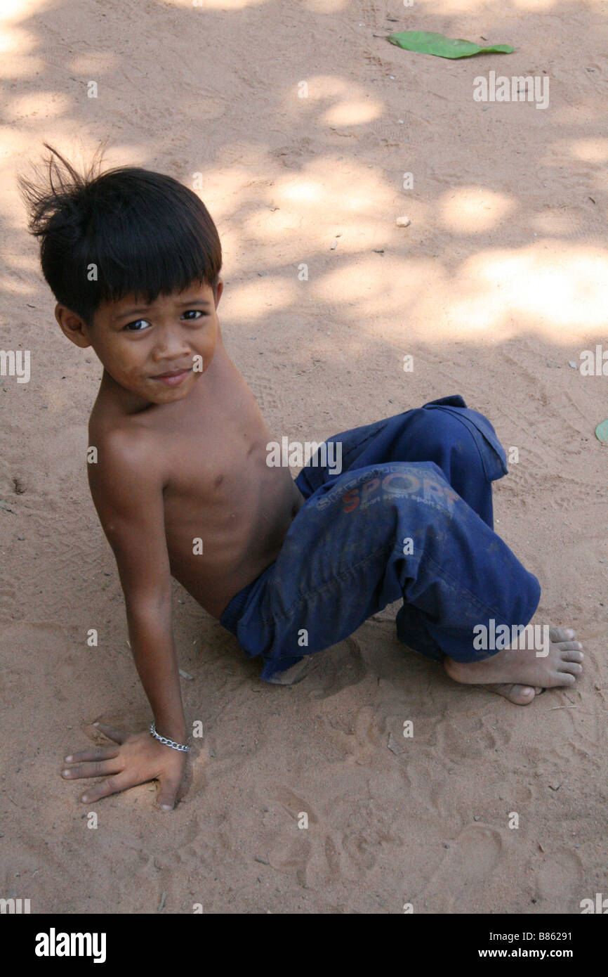 Photograph of a cute Cambodian boy playing near a temple in Siem Reap