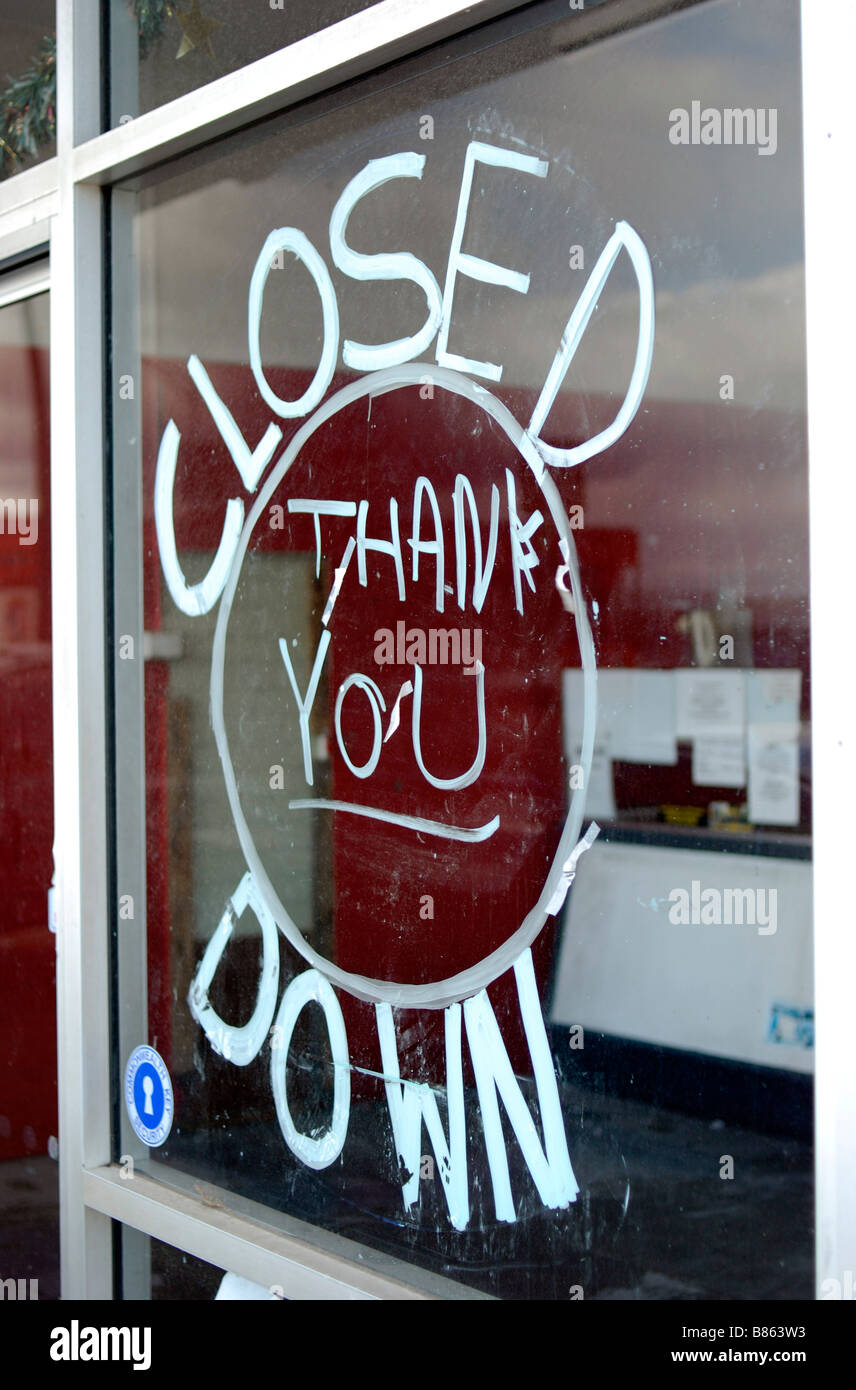 Closed Down written on shop window of a business that has ceased trading Stock Photo