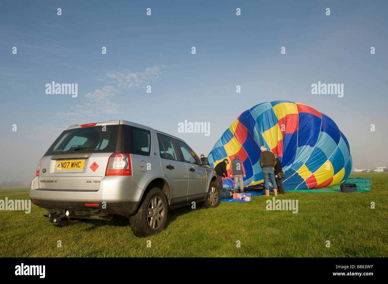 Unpacking a hot air balloon from a Land Rover Freelander and getting it ready for flight Stock Photo