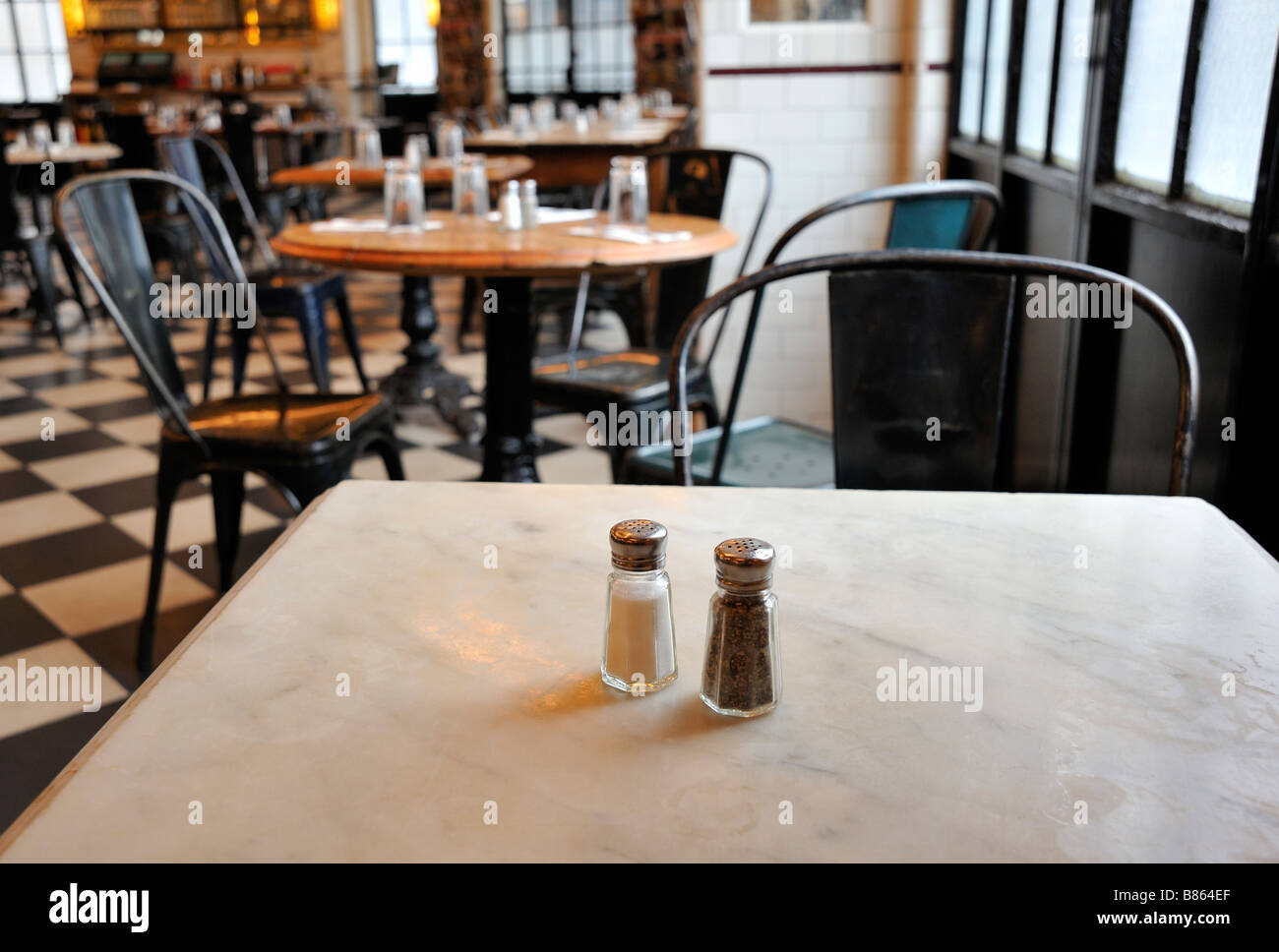 Salt and pepper shakers sit alone on a restaurant table Stock Photo Alamy